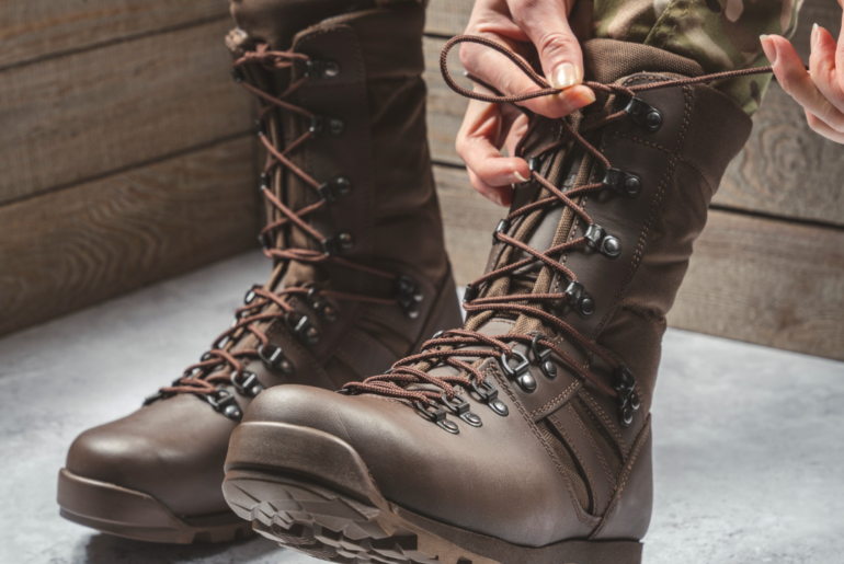 woman tying laces on boots